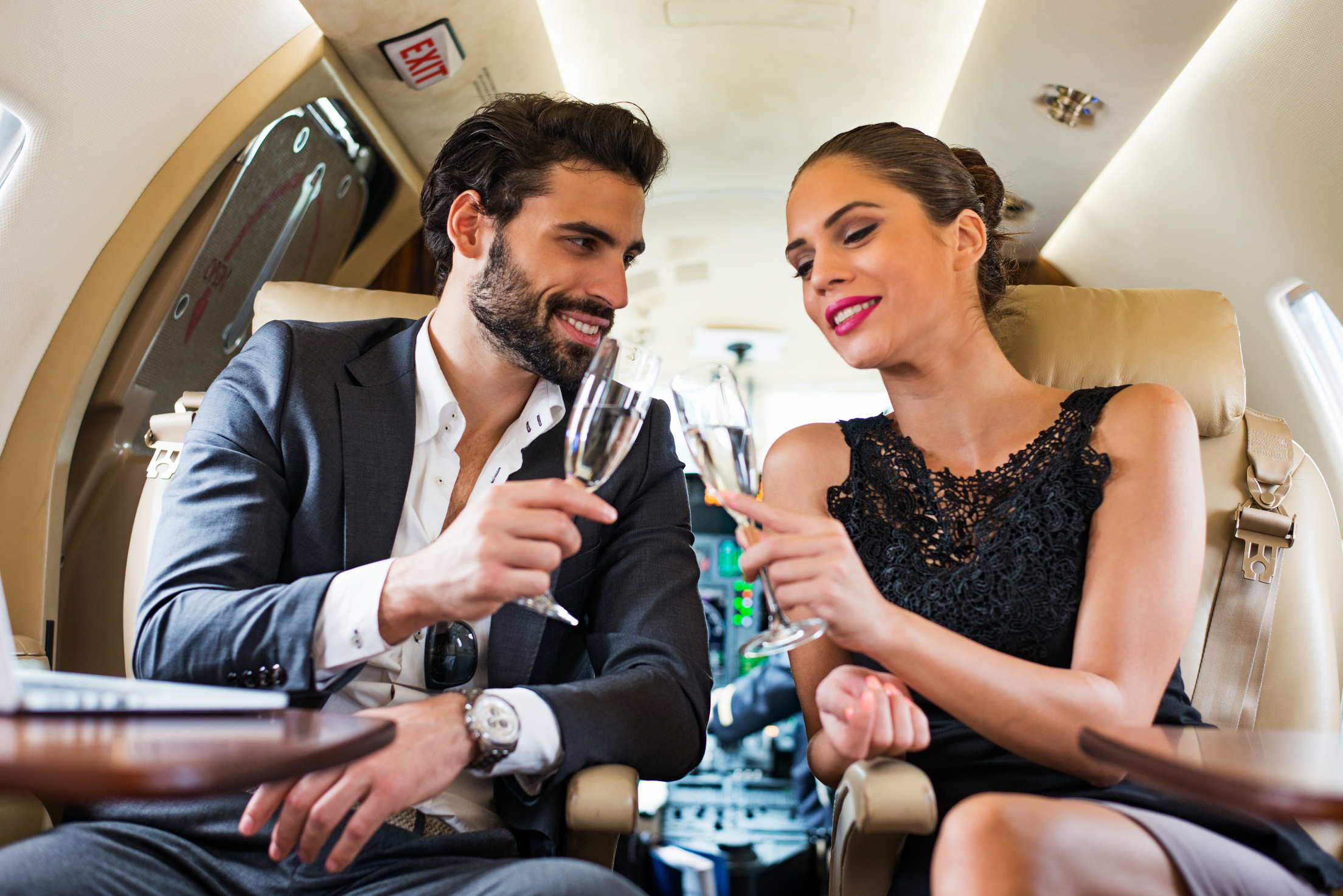 Drinking champagne in private jet airplane